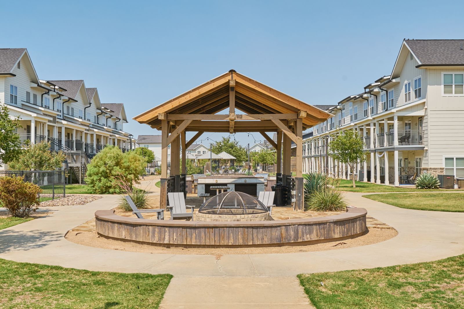 Outdoor pavillion with a grill and lawn chairs