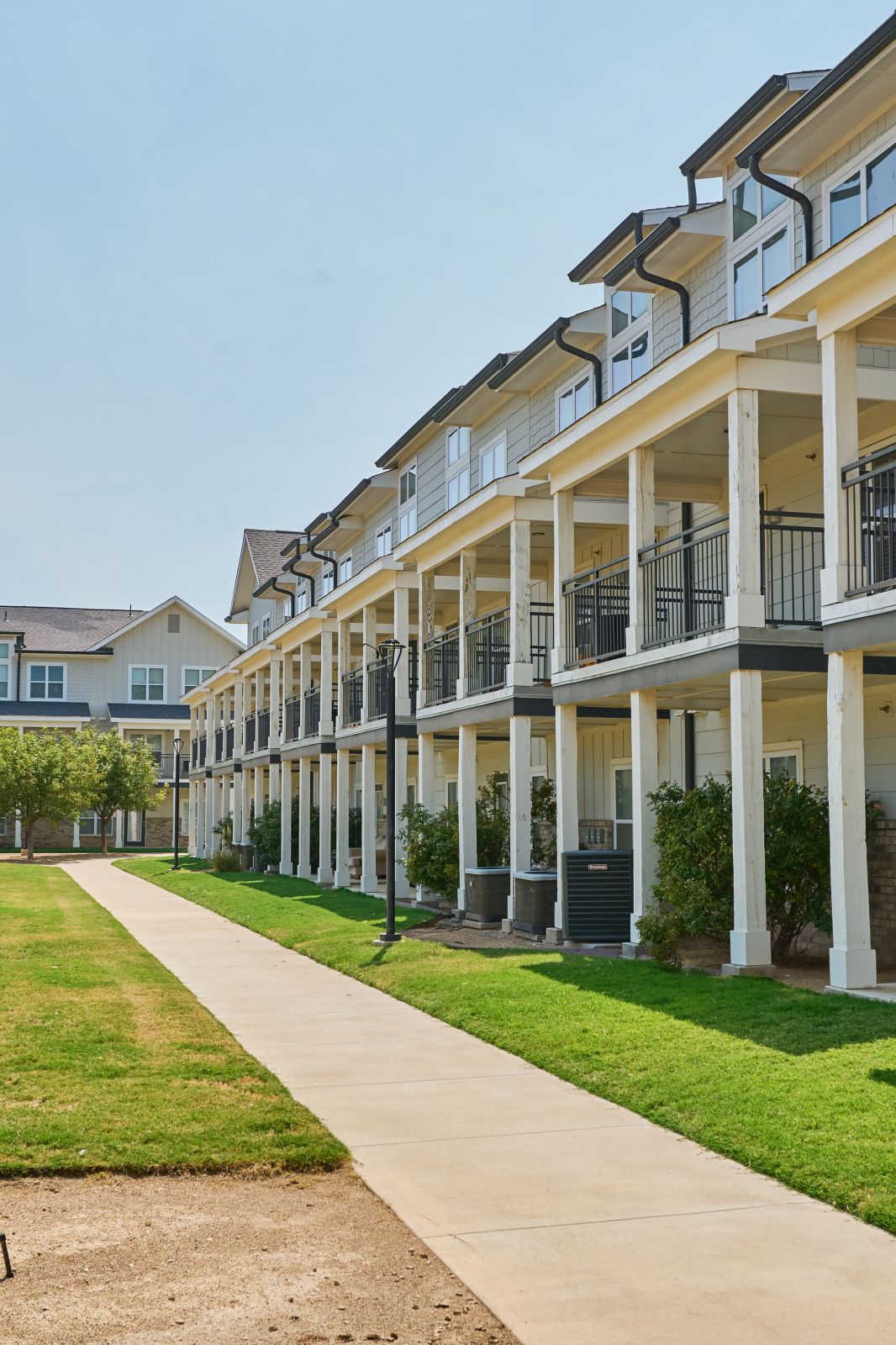 Sidewalk and side view of apartment complex