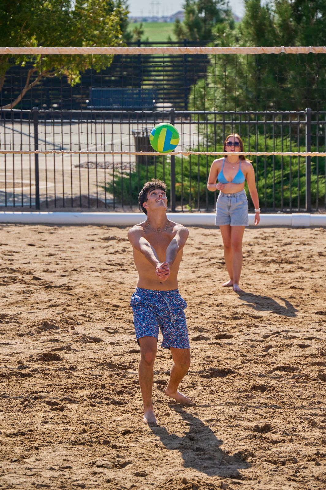 Two people bumping a volleyball