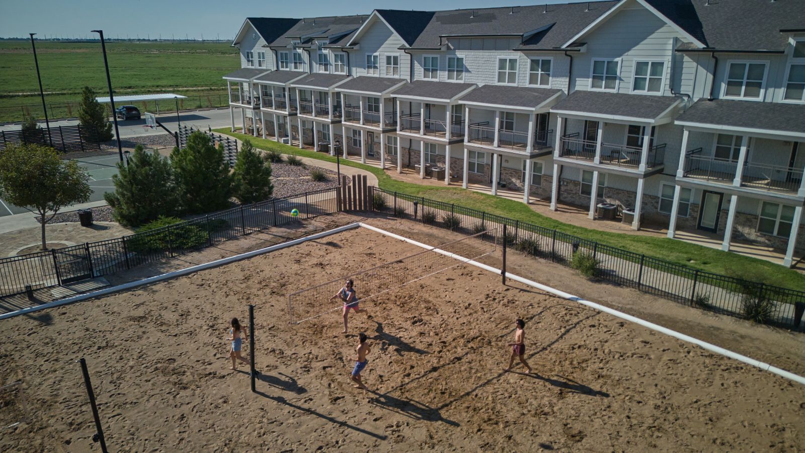 Overhead view of people playing sand volleyball