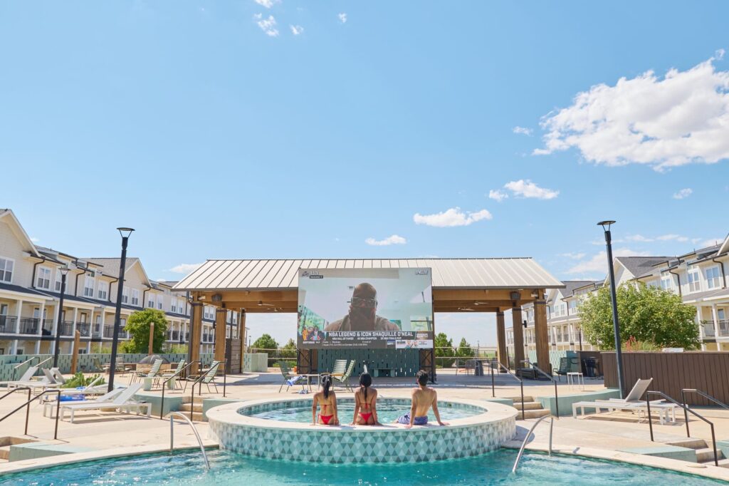 Three people watching a movie in the hottub